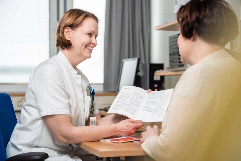 A doctor showing instructions to a patient.