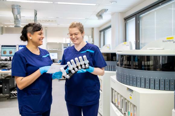 Two Biomedical Laboratory Scientists are looking at research results in the laboratory premises.