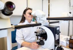 A doctor looking into a microscope.